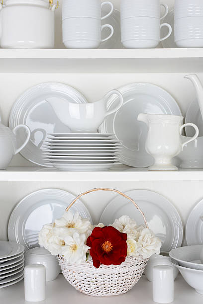 istock White Plates in Cupboard and One Red Rose 508376703