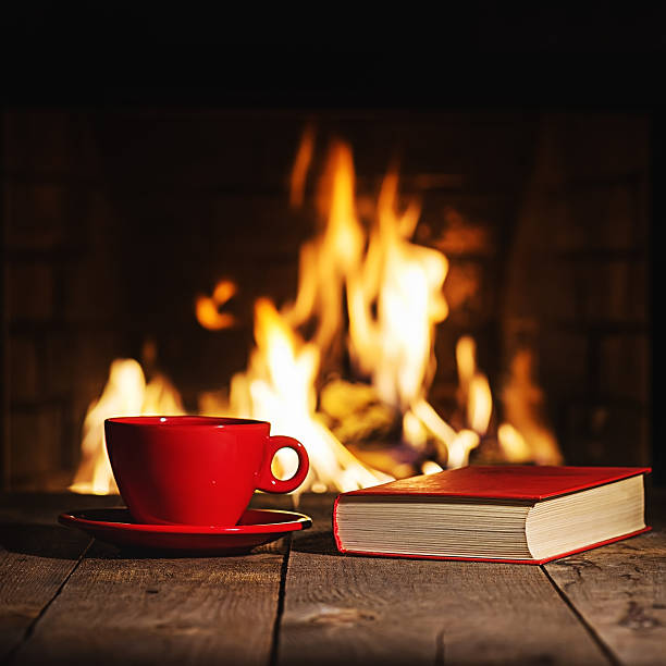 istock Red cup of coffee and old book on wooden table 508377030