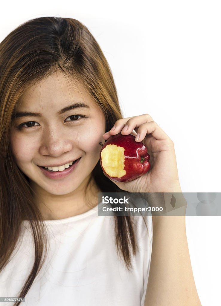 young woman showing an apple. Beautiful young lady showing  red apple  isolated on white. Adult Stock Photo