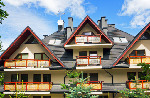 Summer scene with a new apartment house in the mountains in Zakopane, Poland.