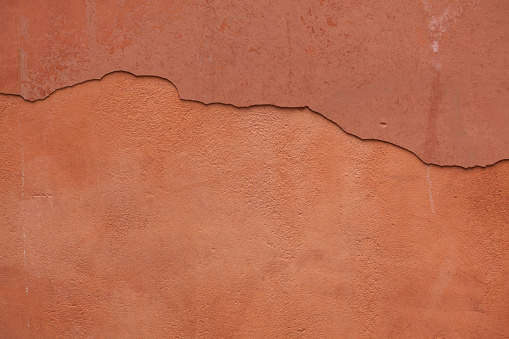 Cloudy, mottled patterned square floor tile, terracotta, surrounded by a grey tile joint or grouting. Red and sandy colored. Italian style. Square orientation. The image has been shot full frame and close up. Ideal for backgrounds. The size of the photo is 2000 x 1943 px.