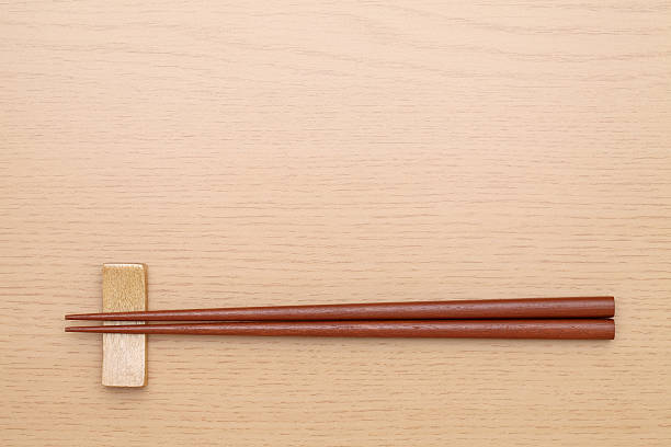 Chopsticks and chopsticks rest Chopsticks and chopsticks rest on wooden table    chopsticks photos stock pictures, royalty-free photos & images