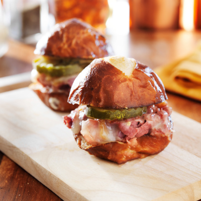 corned beef and cheese slider on pretzel bun, shot close up with selective focus