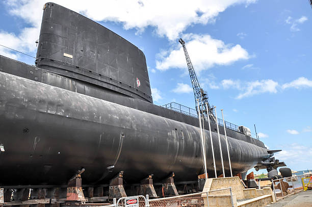 HMAS Ovens Submarine Dry-docked Fremantle,WA,Australia-November 19,2015: HMAS Ovens naval submarine dry-docked in Fremantle, Western Australia with crane. dry dock stock pictures, royalty-free photos & images