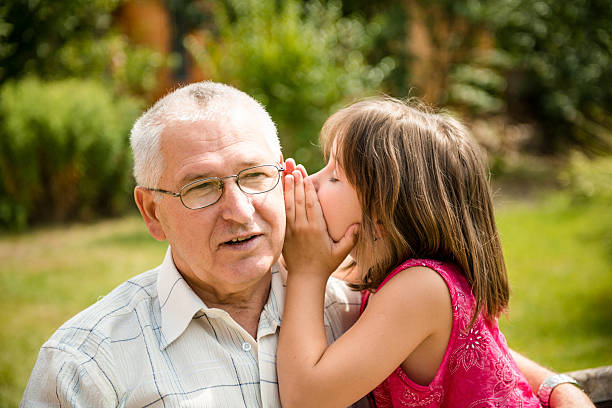 mi dica segreto - whispering grandparent child grandfather foto e immagini stock