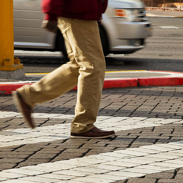istock Cropped image of man crossing the road 508382474