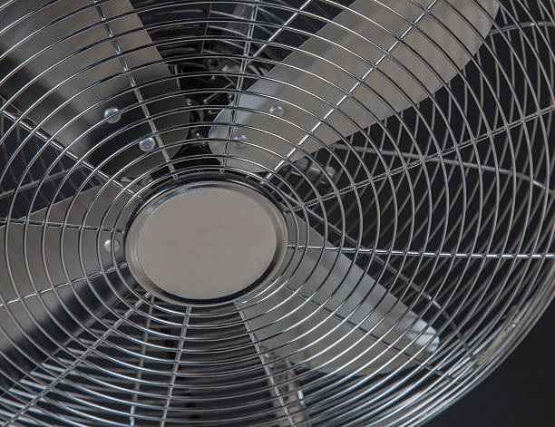 istock closeup metal fan on black background 508384316