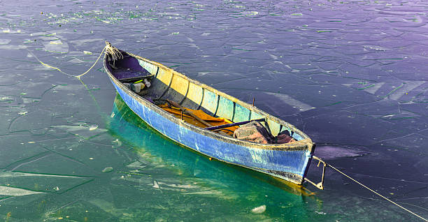 istock fishing boat on the lake and difficult winter conditions 508385724