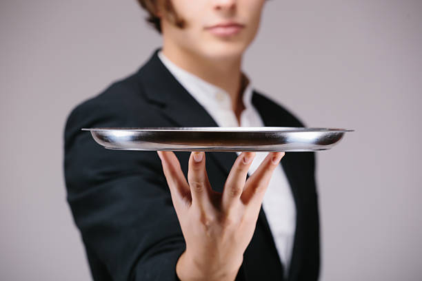 istock Close-up of a handsome man holding an empty silver tray 508386878