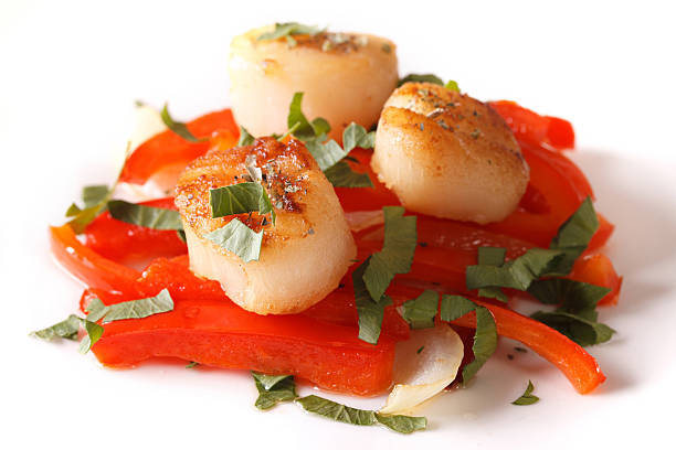istock fried scallops with red pepper close-up on a plate. Horizontal 508387178