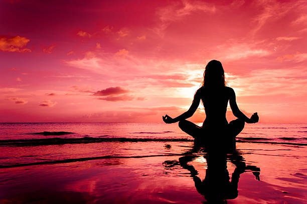 Meditation Silhouette of woman in lotus position sitting in water mantra stock pictures, royalty-free photos & images