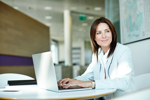 Shot of a businesswoman working on her laptop in the office