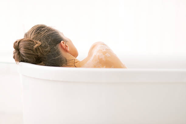 istock young woman relaxing in bathtub. rear view 508398683