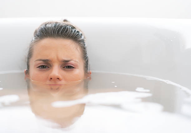istock stressed young woman laying in bathtub 508398687