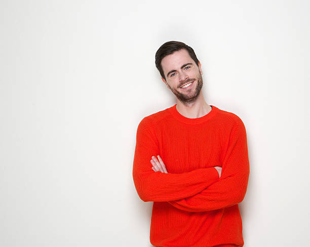 istock Friendly young man smiling with arms crossed 508399425