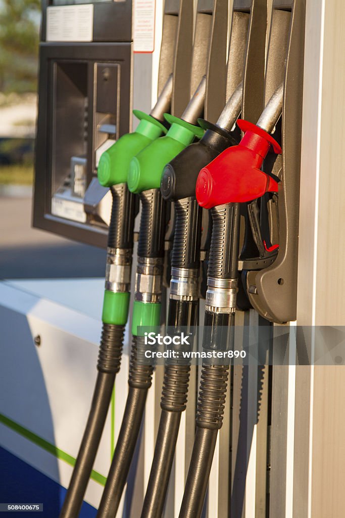 Fuel pumps at petrol station Red, green and black fuel pumps at petrol station Car Stock Photo