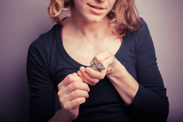 istock Young woman with pet mouse 508402029