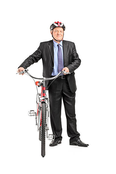 Full length portrait of a mature businessperson holding a bicycle, isolated on white background