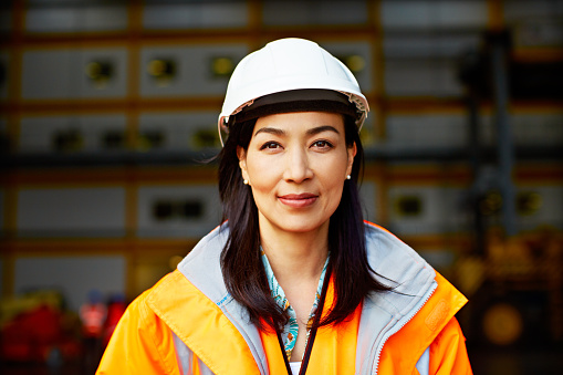 Portrait of a woman in workwear standing on a commercial dock