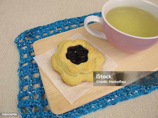 Tea And Flower Biscuit Filled With Blueberry Jam Stock Photo - Download Image Now - Afternoon Tea, Baked, Baking