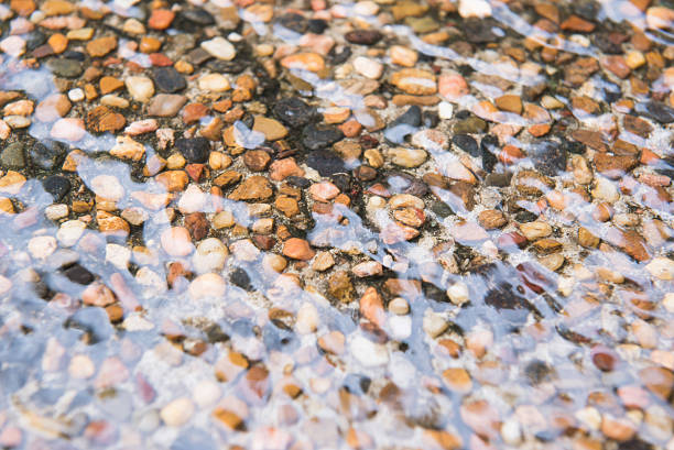 Pebblecrete wet driveway A Pebble Crete Driveway after it has been raining giving this glossy wave wet look of the pebble Crete driveway pebble driveway stock pictures, royalty-free photos & images