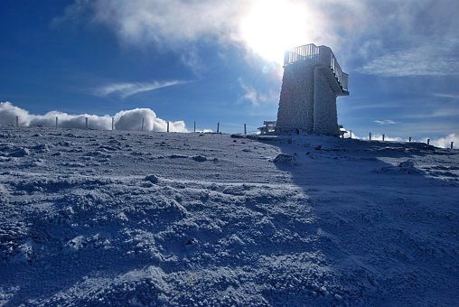 lookout on Pretulalpe hill in winter Fischbacher Alpen with sun in Styria near Murzzuschlag city