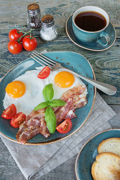 istock Fried eggs,  bacon, tomato, toast and a cup of coffee 508408318