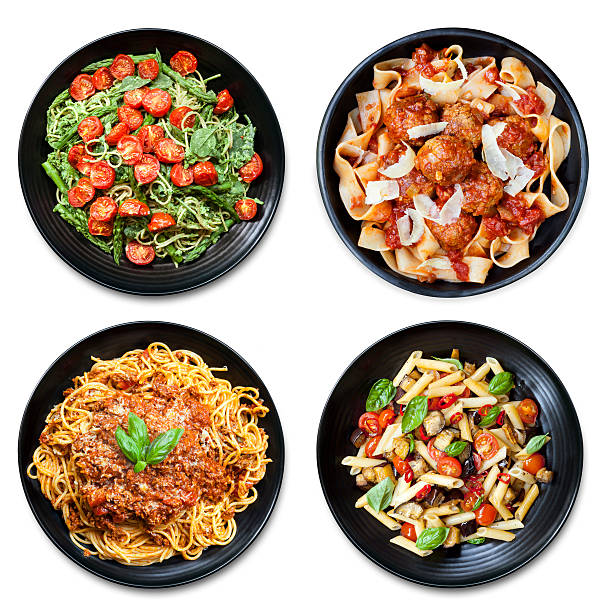 Pasta Collage isolated Overhead View Pasta collage of meals on black plate, isolated on white.  Overhead view.  Includes spaghetti, fettucine, penne and ribbon. penne meatballs stock pictures, royalty-free photos & images