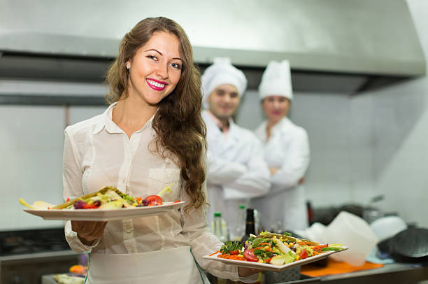 istock Female waiter taking dish at kitchen 508410564