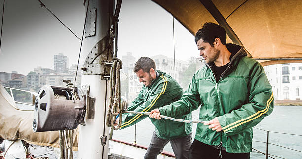 Sailing crew winding winch sydney Australia stock photo