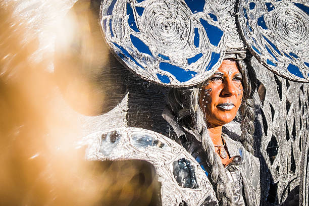 Woman dressed in elaborate, reflective costume attends the Venice Carnival Venice, Italy - February 4, 2016: Woman dressed in a highly elaborate, reflective costume poses for photographers in the sunshine during the 2016 Venice Carnival. mardi gras body painting stock pictures, royalty-free photos & images