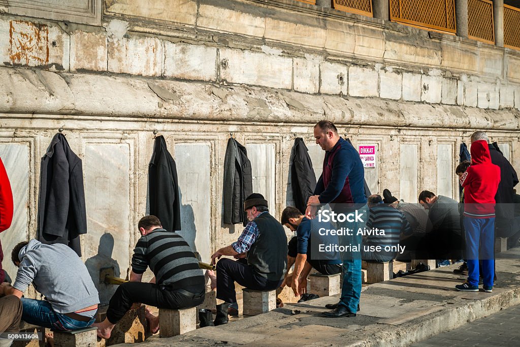 New Mosque in Istanbul, Turkey Istanbul, Turkey - January 31, 2016: Men are washing feet before praying in the New mosque in Istanbul, Turkey Adult Stock Photo