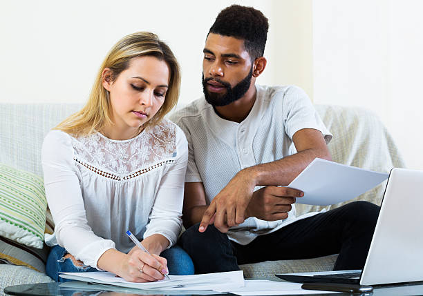 istock Couple filling papers for mortgage 508413680