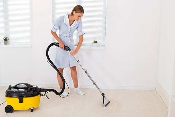 istock Female Maid Cleaning With Vacuum Cleaner 508415410