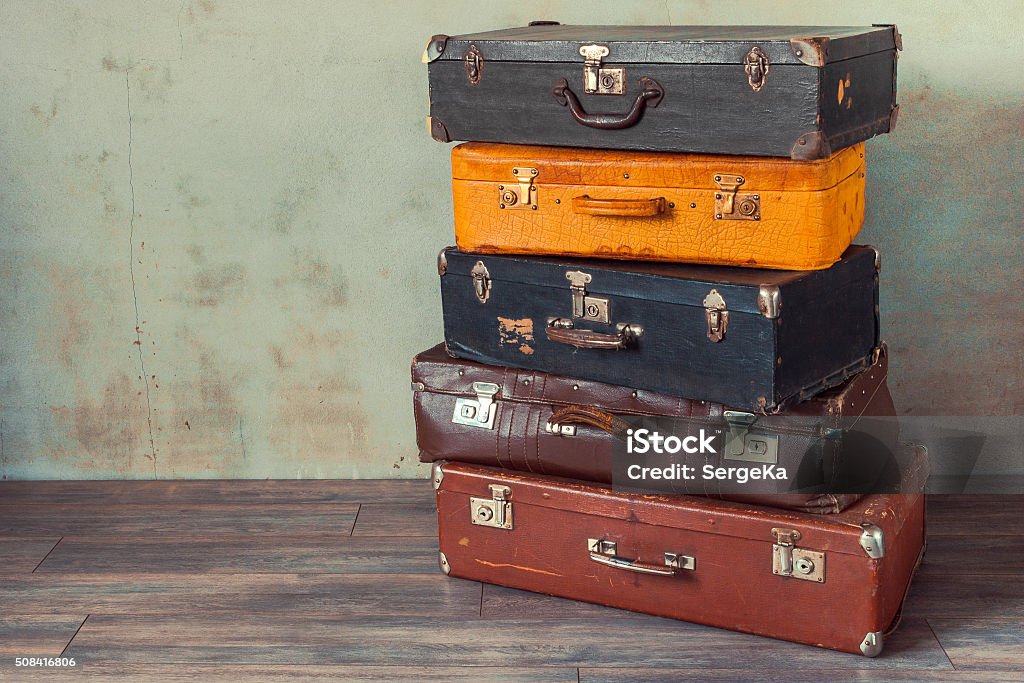 Old suitcases Many old suitcases stand in an empty room Suitcase Stock Photo