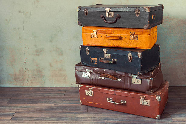 Old suitcases Many old suitcases stand in an empty room suitcase luggage old fashioned obsolete stock pictures, royalty-free photos & images