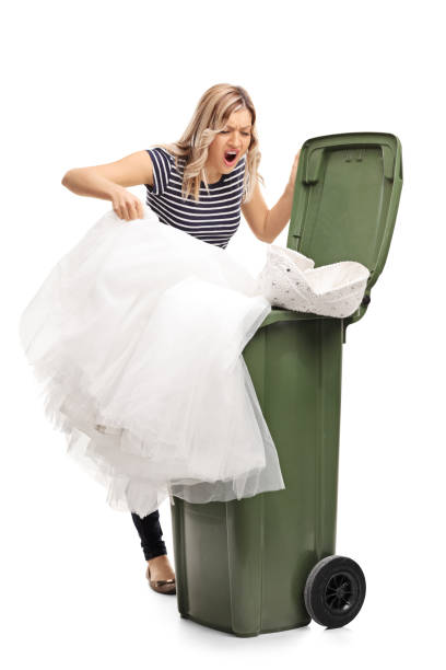 istock Woman throwing her wedding dress in trash 508418762