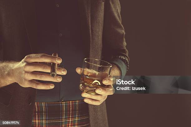 Man Drinking Whiskey And Smoking Cigar Close Up Of Hands Stock Photo - Download Image Now