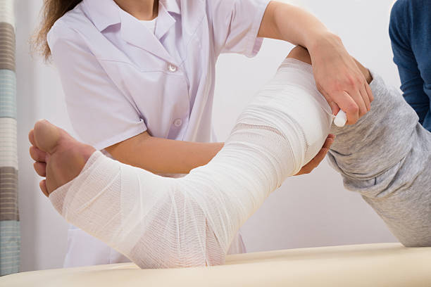 istock Doctor Bandaging Patient's Leg 508419282