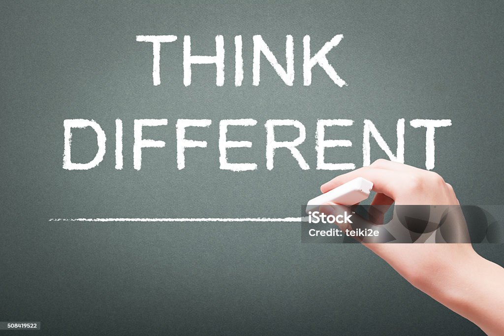 Hand writing with chalk think different concept Hand writing with chalk think different concept on blackboard Activity Stock Photo