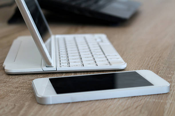 Office workspace with mobile phone and tablet stock photo