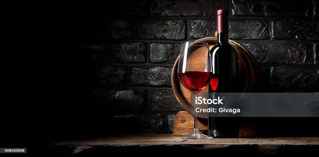 Wine and bricks Red wine on a background of old black bricks Wine Stock Photo