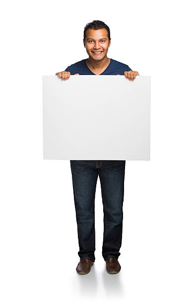 istock Young latin man holding sign in front 508421123