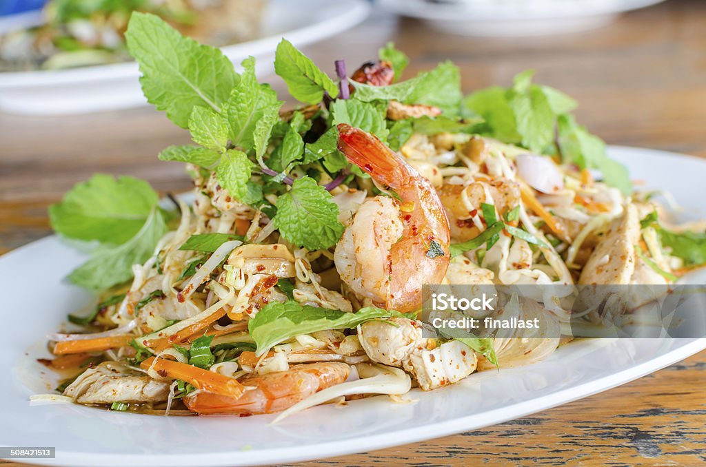 Thai Spicy salad with chicken, shrimp, fish and vegetables Appetizer Stock Photo