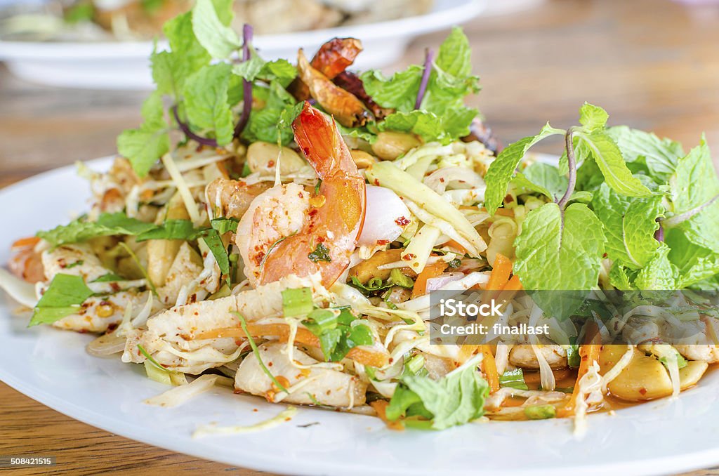 Thai Spicy salad with chicken, shrimp, fish and vegetables Appetizer Stock Photo