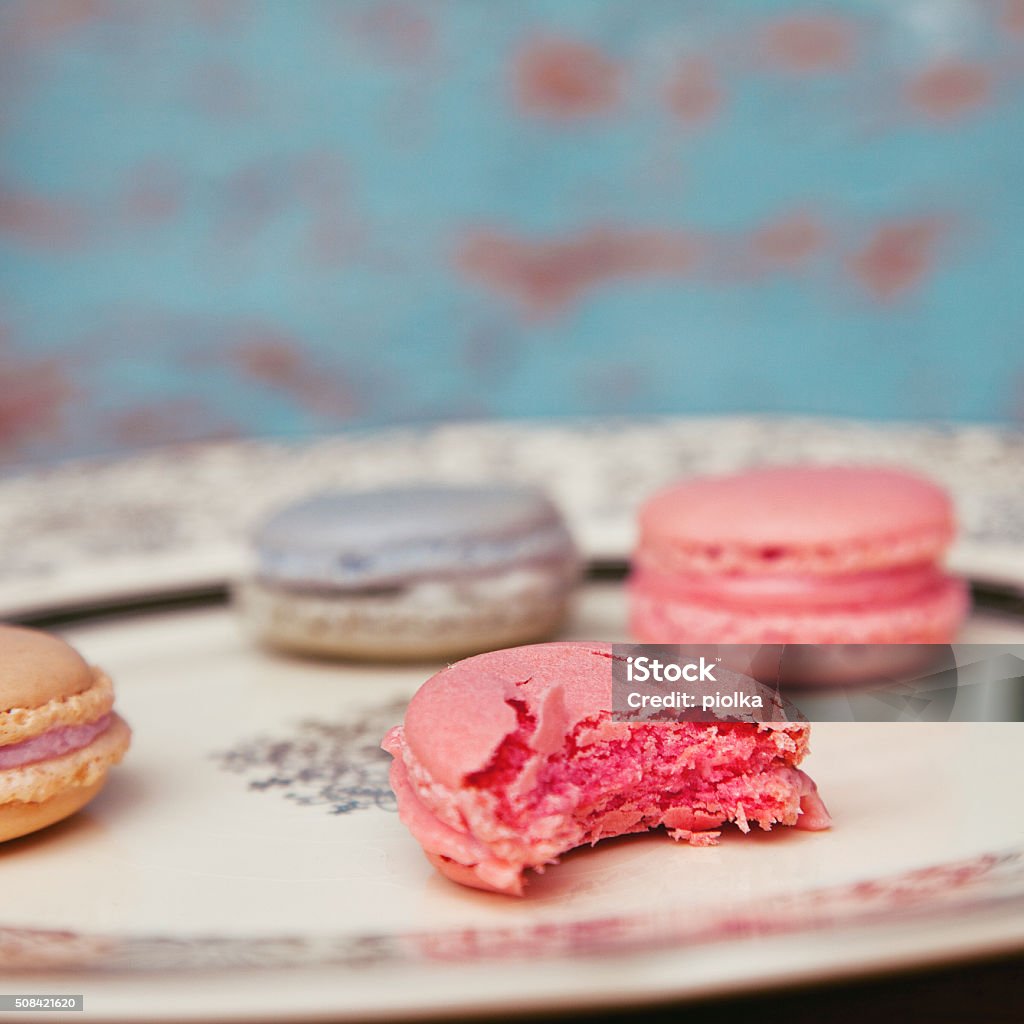 colorful macarons with antique plate on turquoise background colorful macarons with antique plate on turquoise background, food background, shabby chic look Afternoon Tea Stock Photo