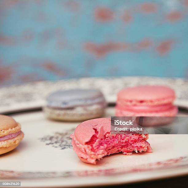 Colorful Macarons With Antique Plate On Turquoise Background Stock Photo - Download Image Now