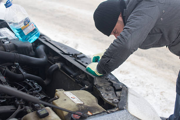 istock man repairing a car in winter 508422208