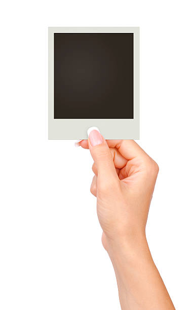 istock one instant photo in hand isolated on white 508422542