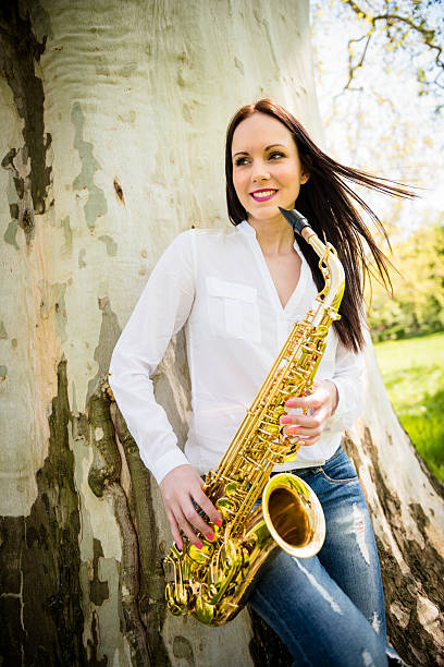 istock Woman with saxophone in nature 508422676